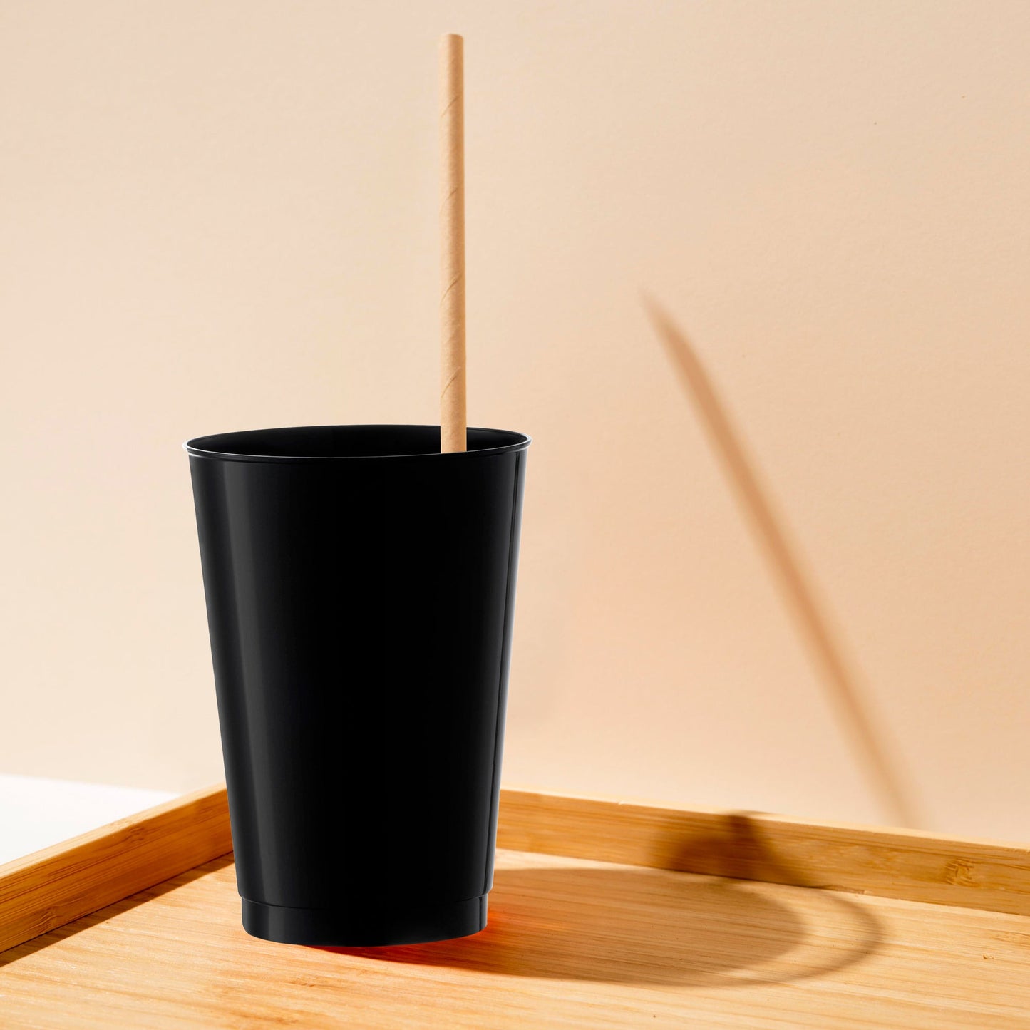 12 oz. Black Plastic Tumblers shown in a lifestyle party setting for bold drink service