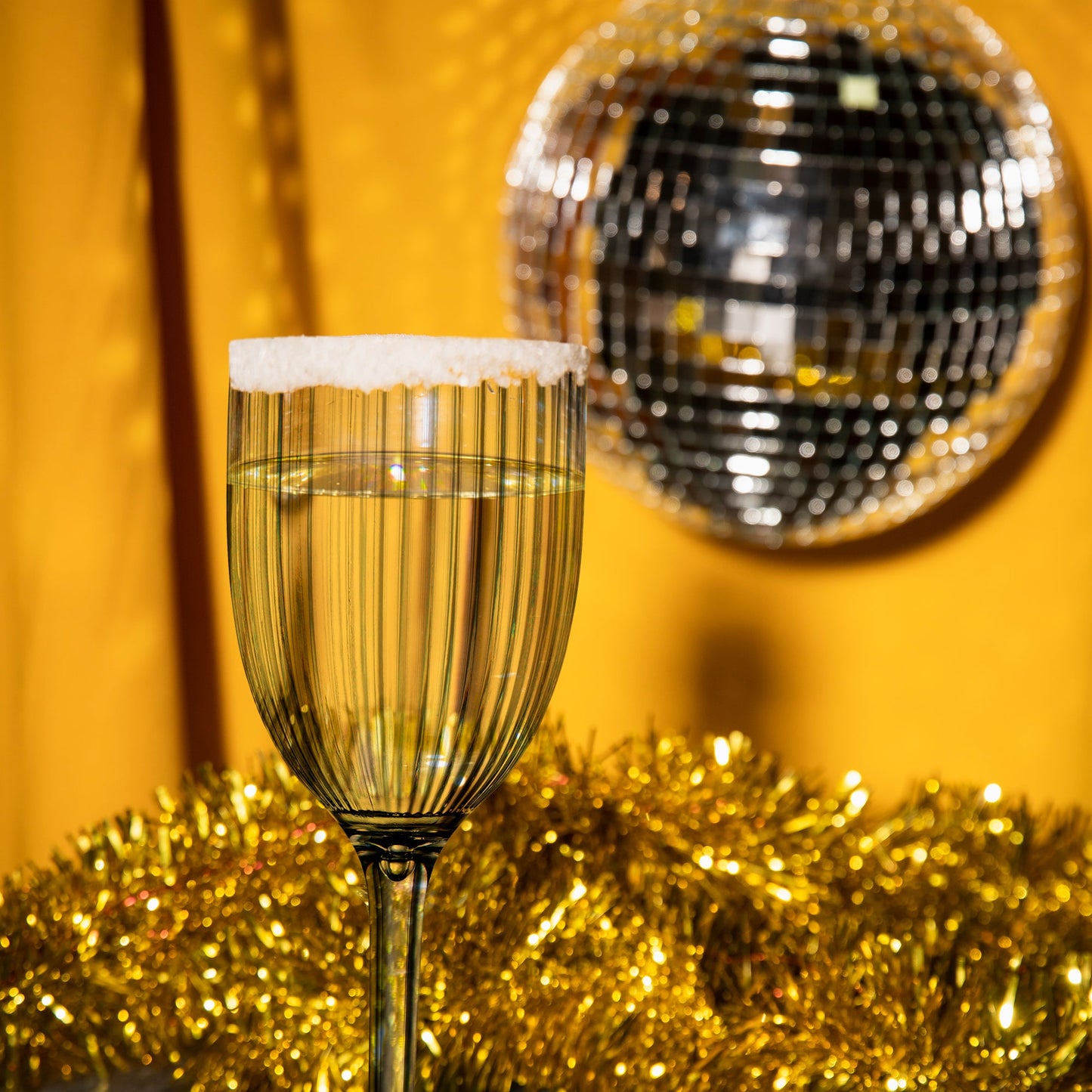 12 oz. Clear Stripe Wine Flutes arranged on a tray, ready to serve drinks at a formal gathering