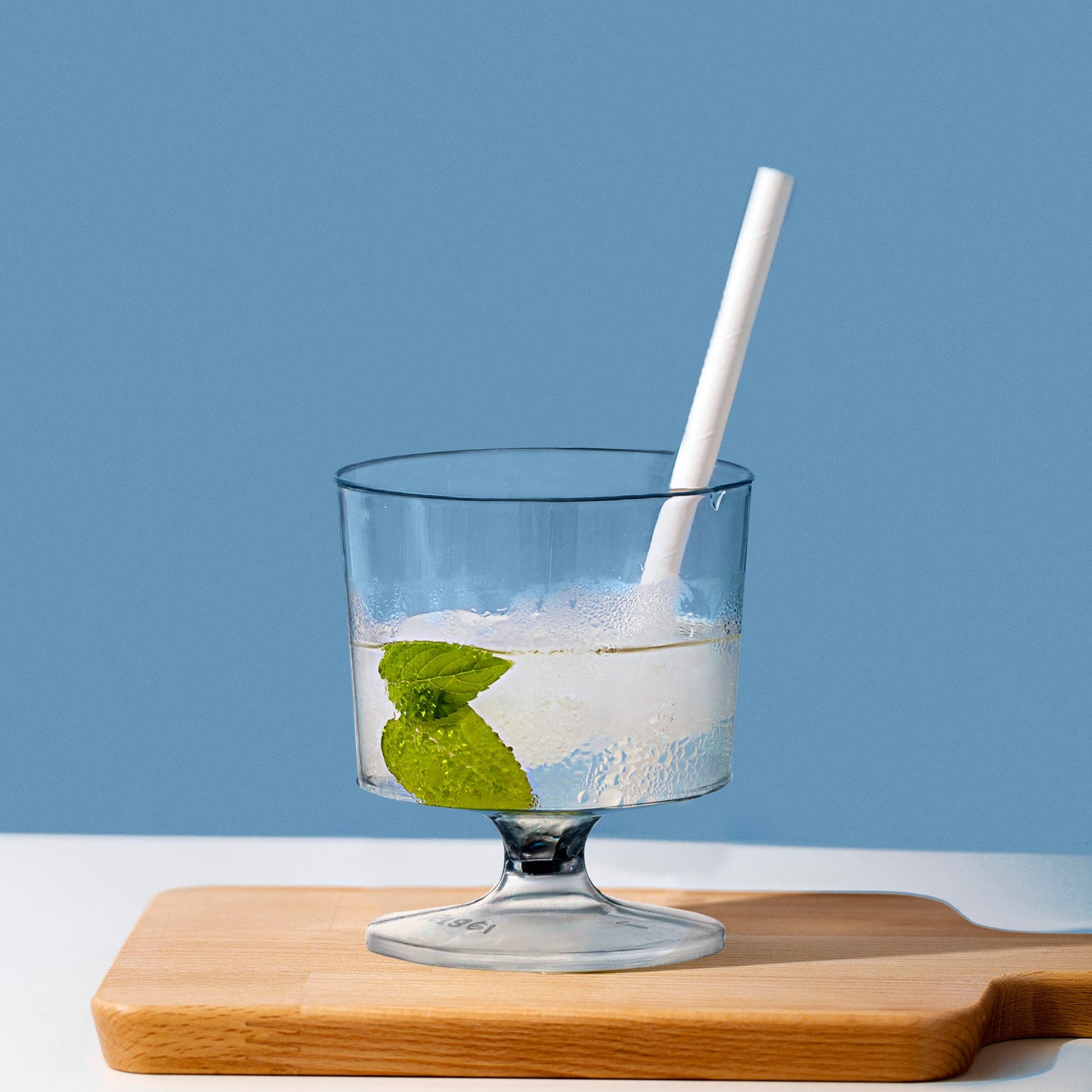 2 oz. Clear Round Plastic Disposable Mini Wine Glasses used during a modern celebration with appetizers and drinks