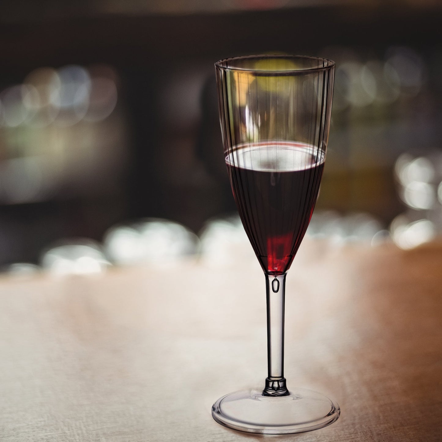 8 oz. Clear Stripe Champagne Flutes displayed at a wedding toast setup, filled with bubbly champagne