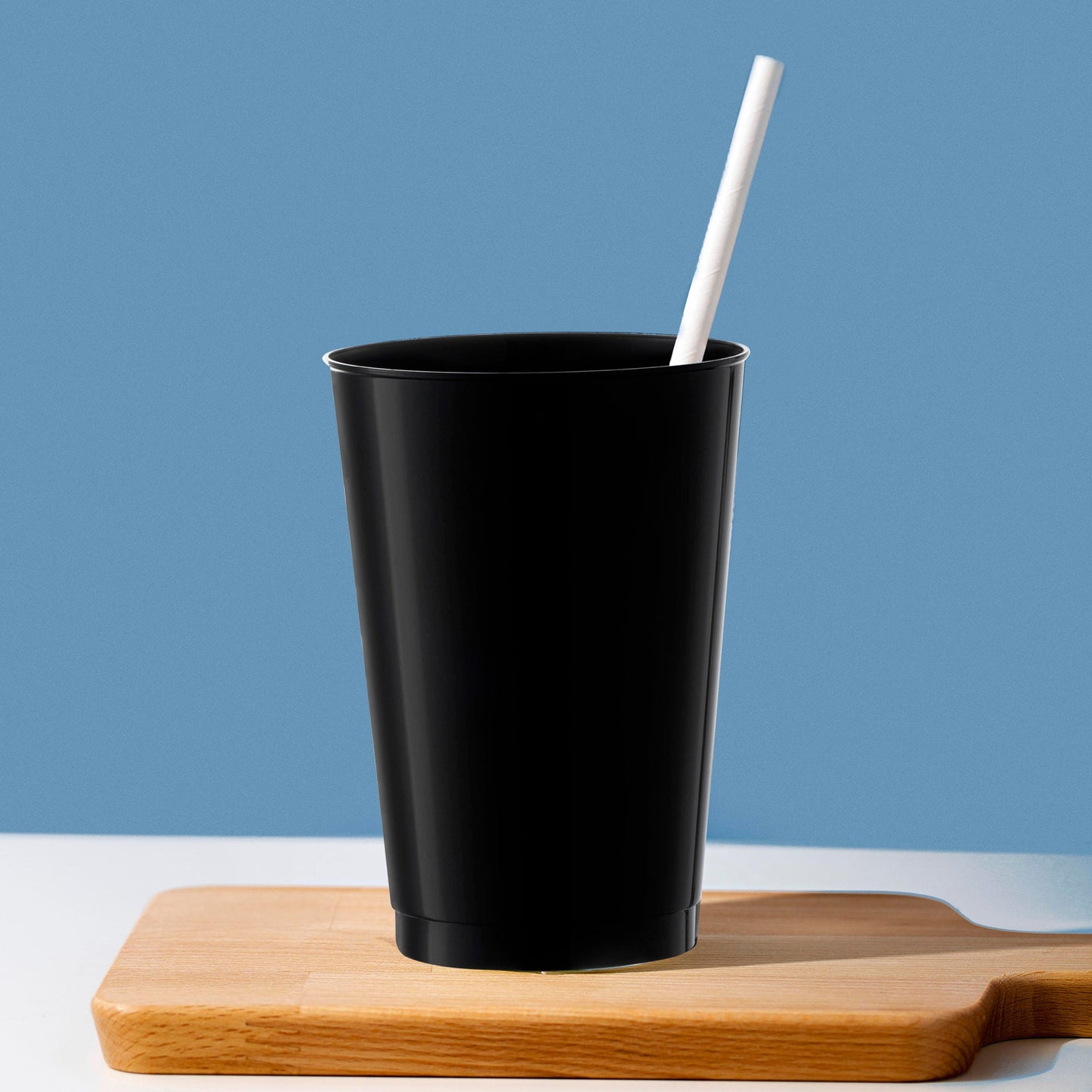 Black 12 oz. tumblers placed on a sleek table setup, ready to serve cocktails in style