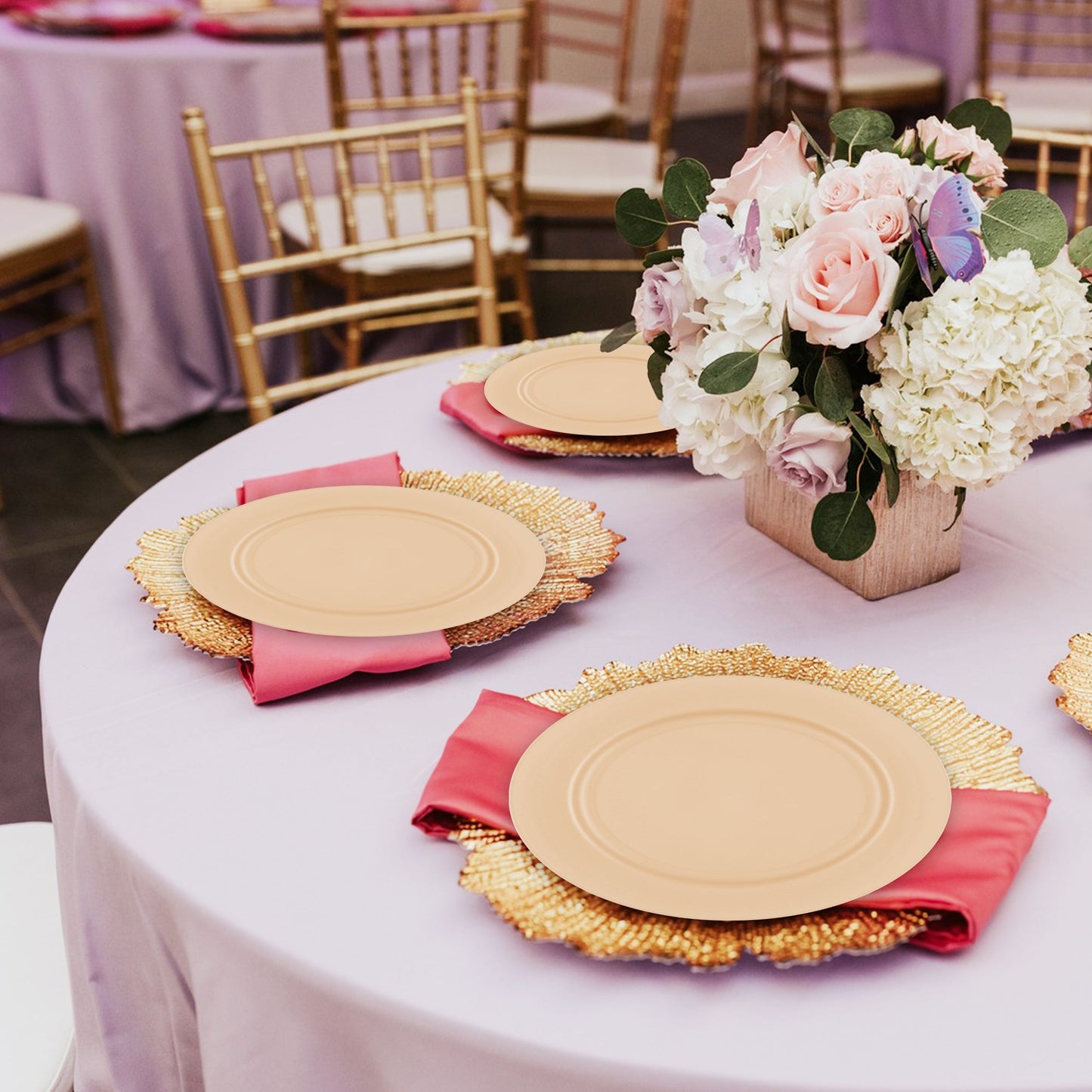 Bright yellow plates adding a vibrant pop to a spring event table with greenery and citrus-toned centerpieces