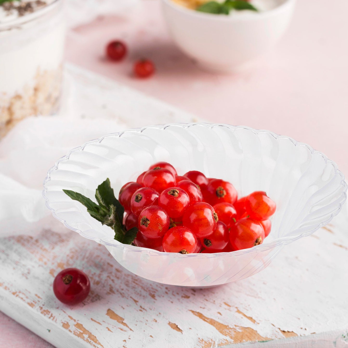 Clear Flair Plastic Soup Bowl with transparent flared design, filled with vibrant cherry tomatoes