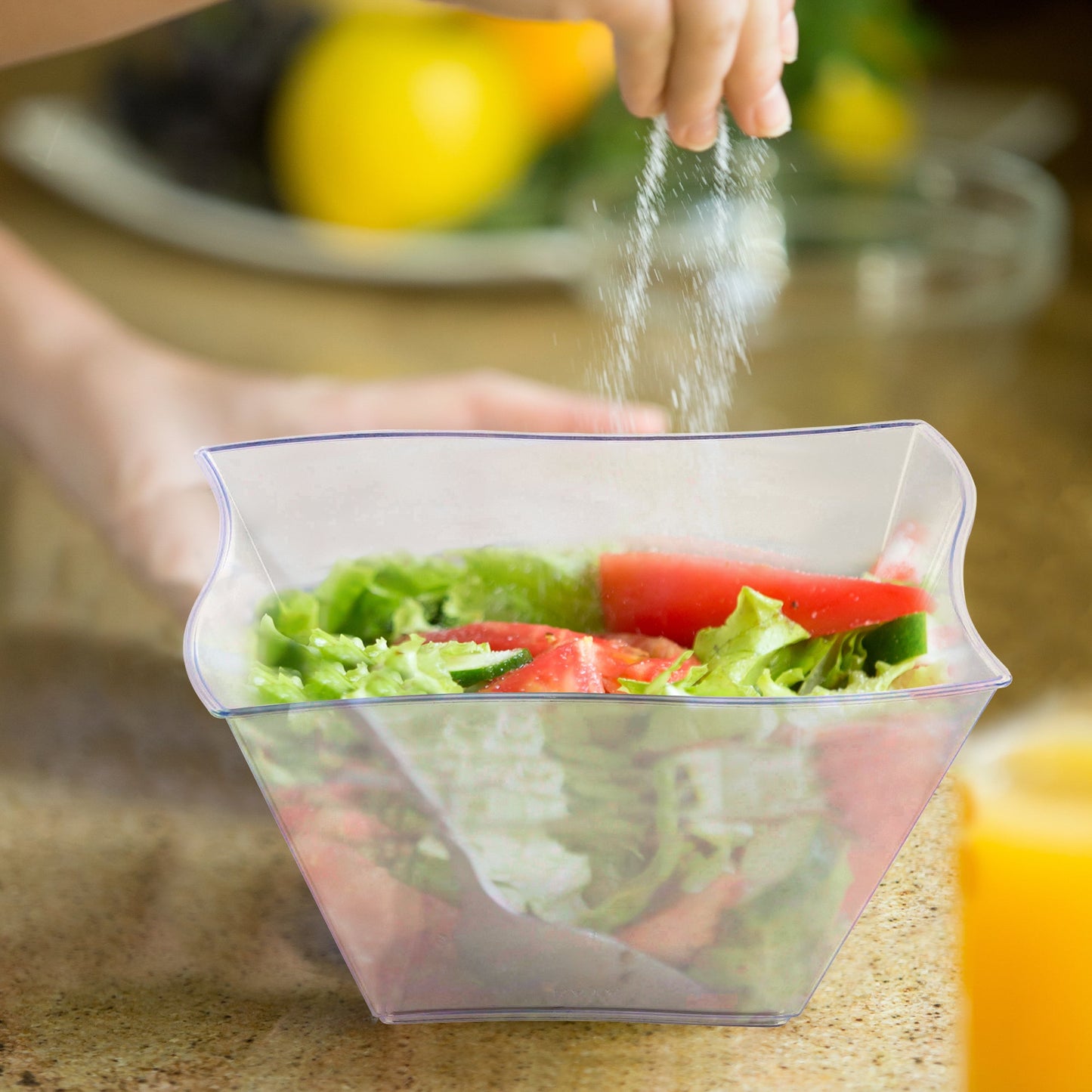 Clear Wave Plastic Soup Bowl showcasing a fresh salad with crisp lettuce and ripe tomatoes