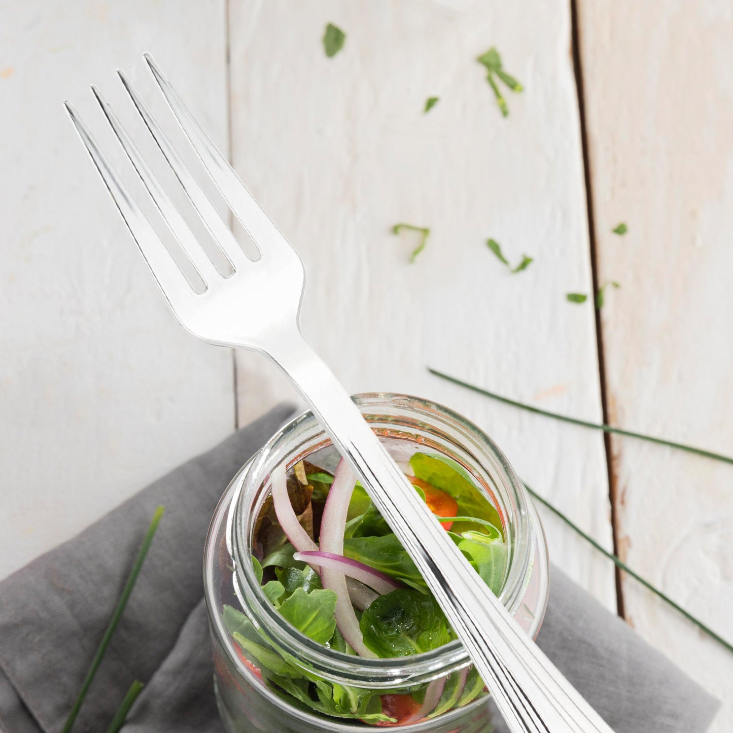 Elegant silver plastic forks with a high-shine metallic finish and textured grooves, 6.75 inches, set of 600
