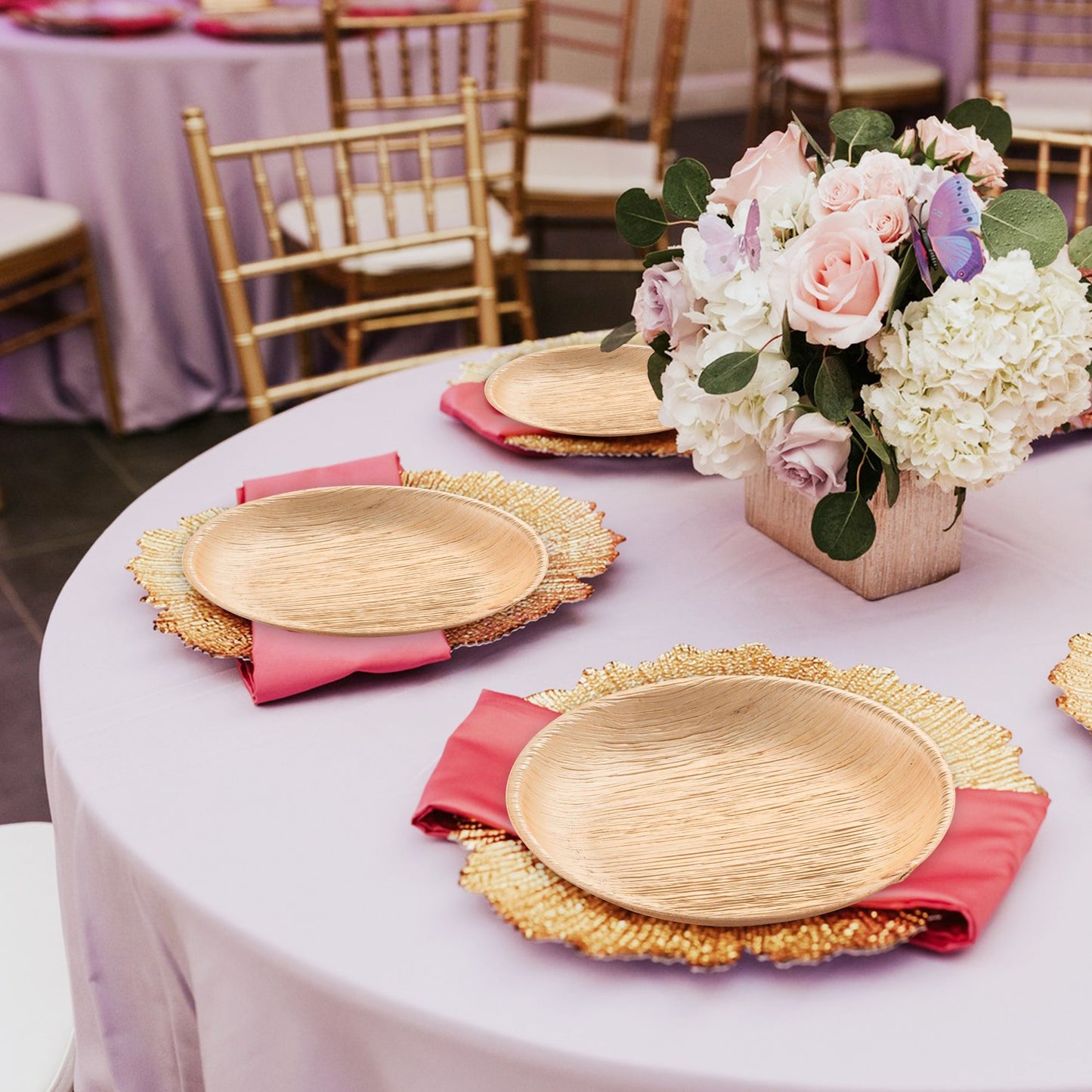 Natural dinnerware arranged on rustic tables—round palm leaf salad plates holding fresh seasonal greens.