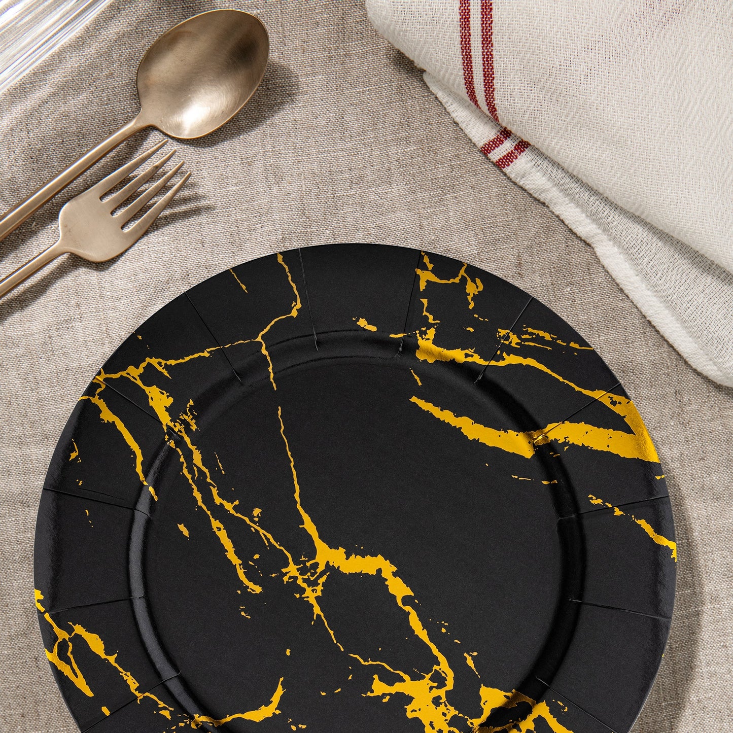 Scene from a party setup showing Black with Gold Marble Round Charger Plates (13") beside gourmet food and d
