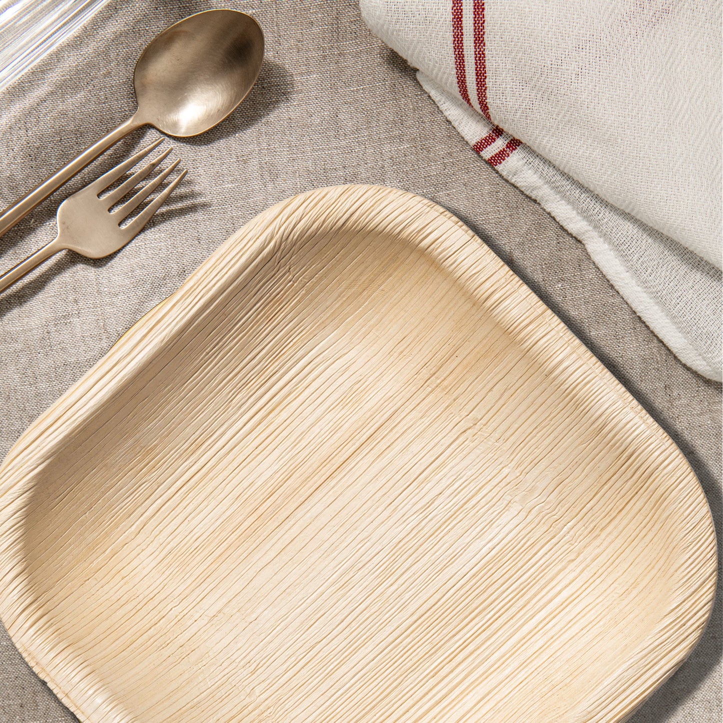 Square Palm Leaf 4" Pastry Plates displayed with fresh flowers on a rustic table for a charming dessert spread