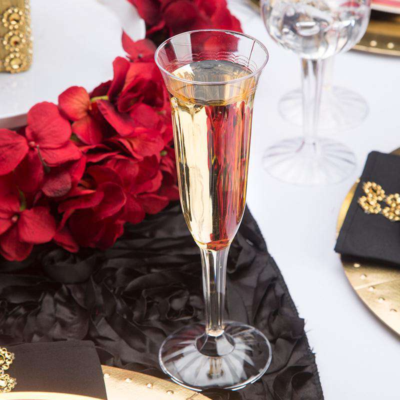 Versatile 5 oz. clear plastic champagne flutes, perfect for serving sparkling wine, mimosas, or prosecco at formal and casual events