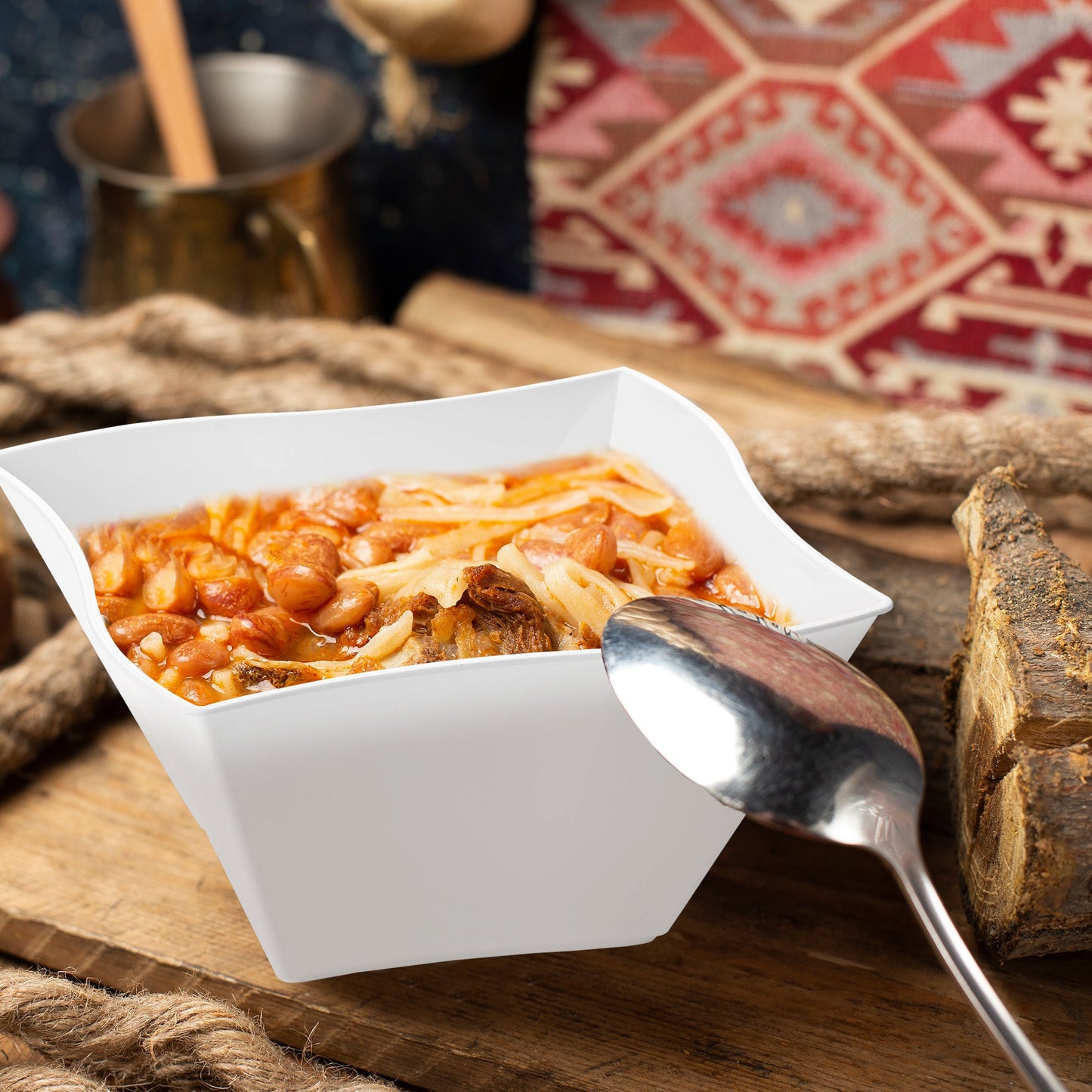 White Wave Plastic Soup Bowl (14 oz.) filled with hearty chili, topped with melted cheese and red beans