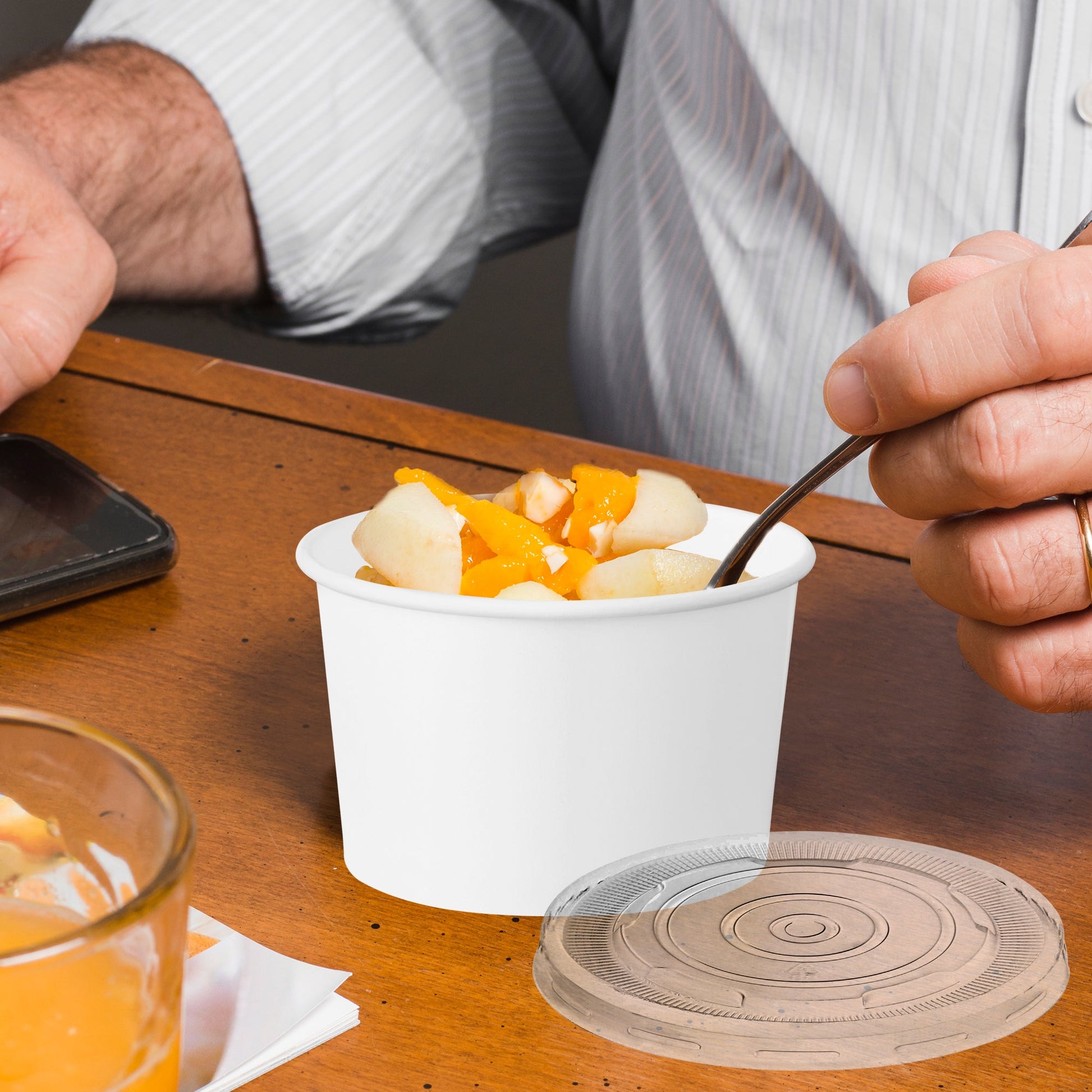 12 oz Squat Paper Soup Cups with Lids used at an outdoor food stand, keeping meals hot and spill-protected