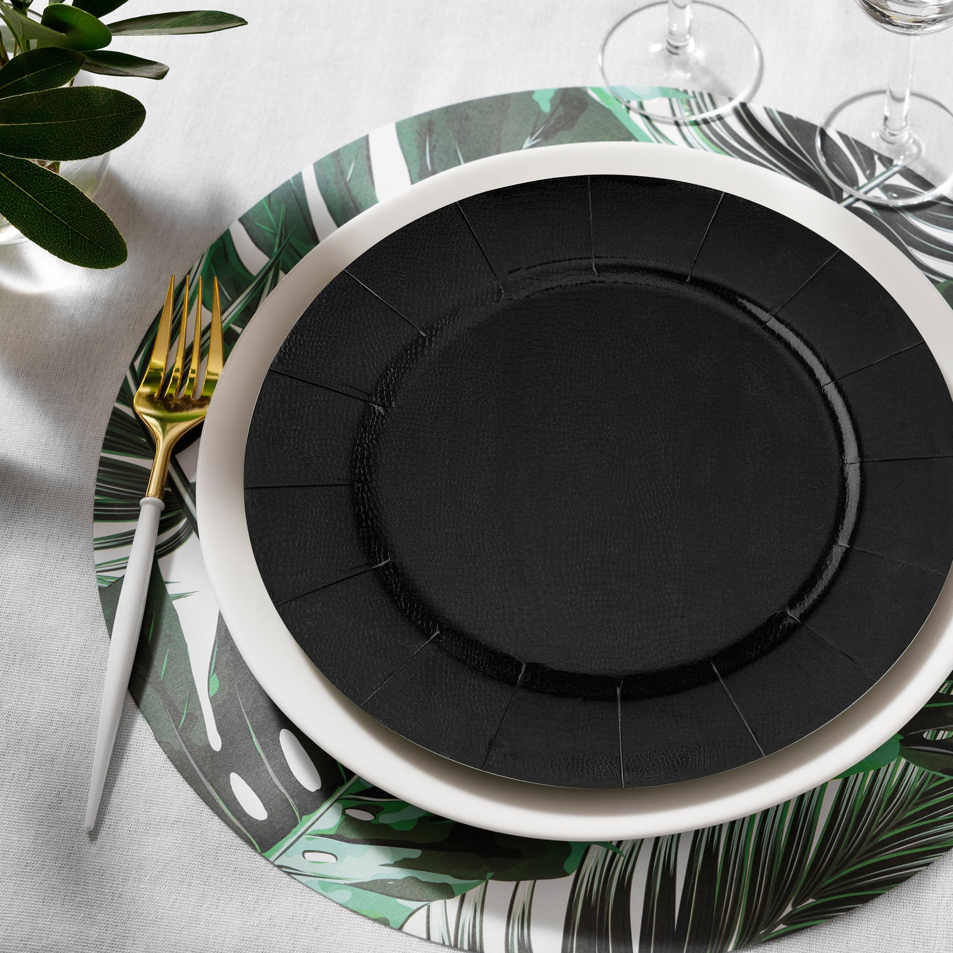 Black Round   Charger Plates (13") placed neatly on a banquet table with candles and folded napkins for stylis
