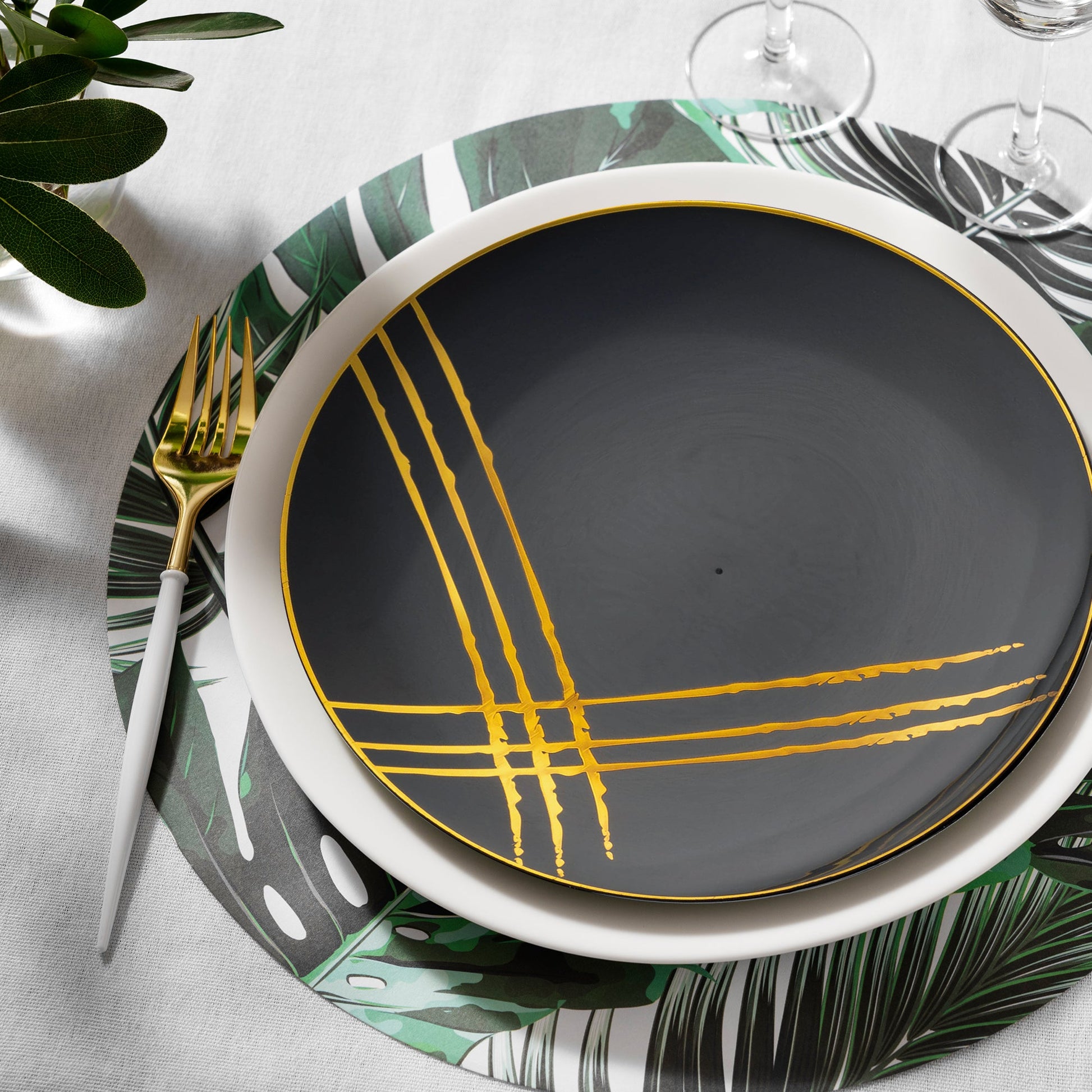Black with Gold Brushstroke Dinner Plates held gourmet meals at a formal black-and-gold celebration.