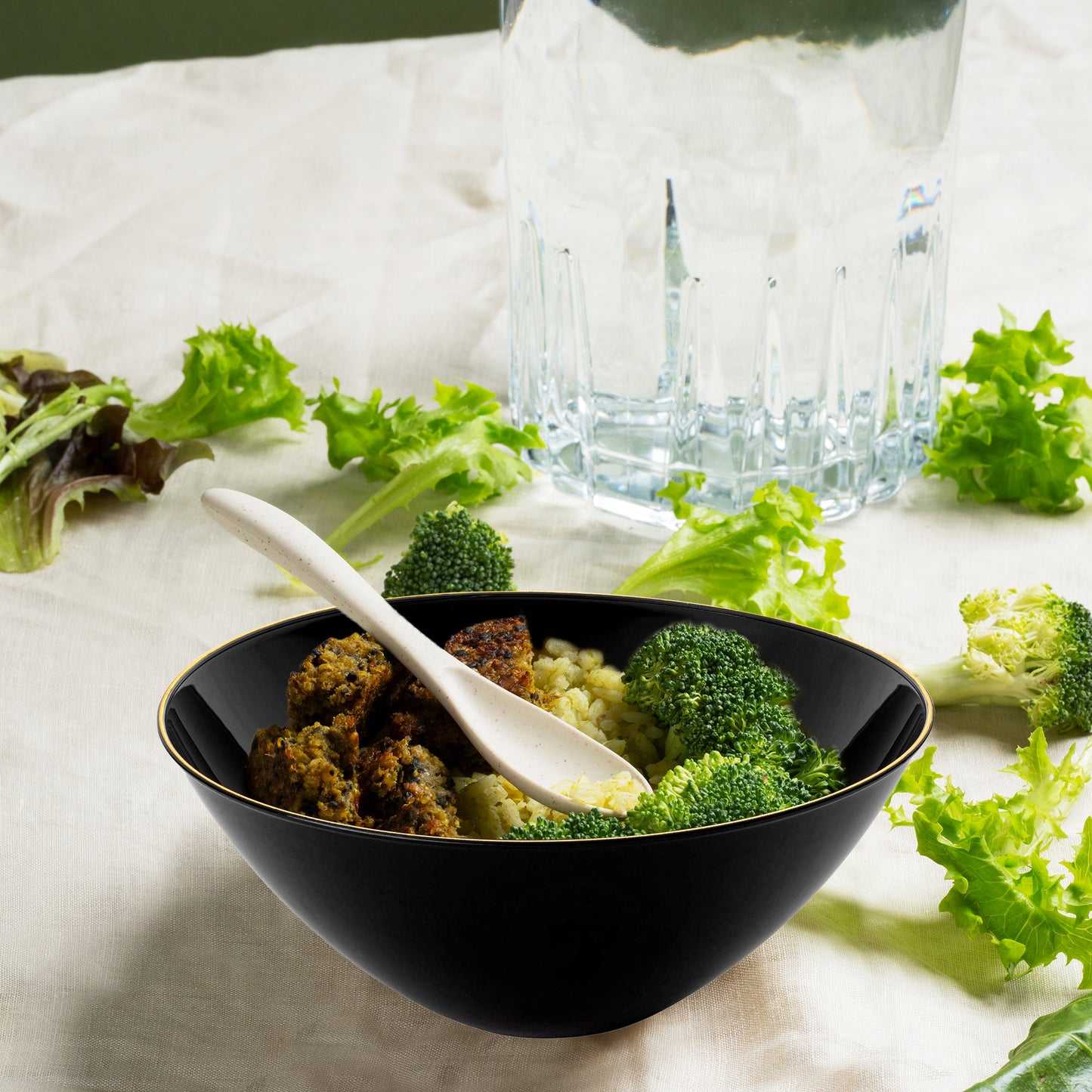 Black with Gold Rim Organic Round Disposable Plastic Bowl (32 oz.) served with grilled meat, seasoned rice, and steamed broccoli florets