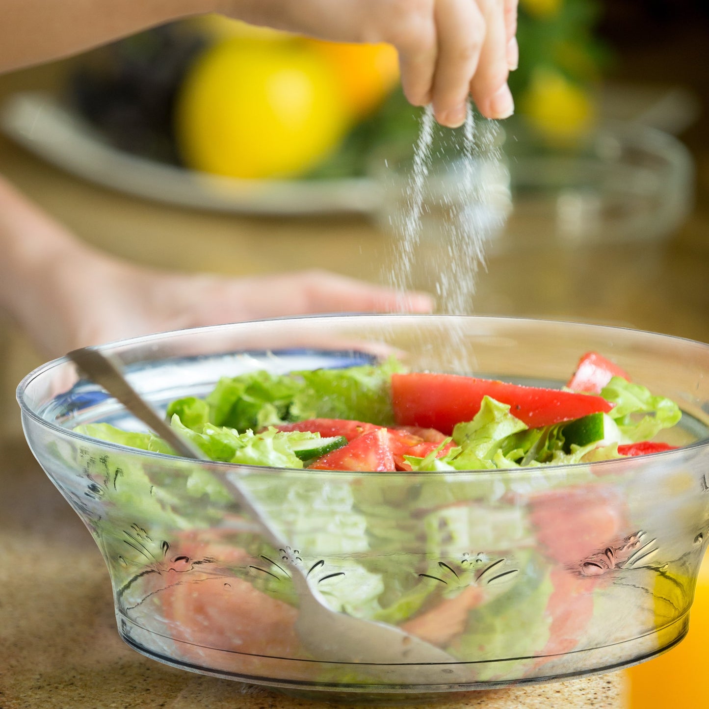 Clear Floral Round Disposable Plastic Soup Bowl (10 oz.) containing fresh lettuce and ripe tomato slices