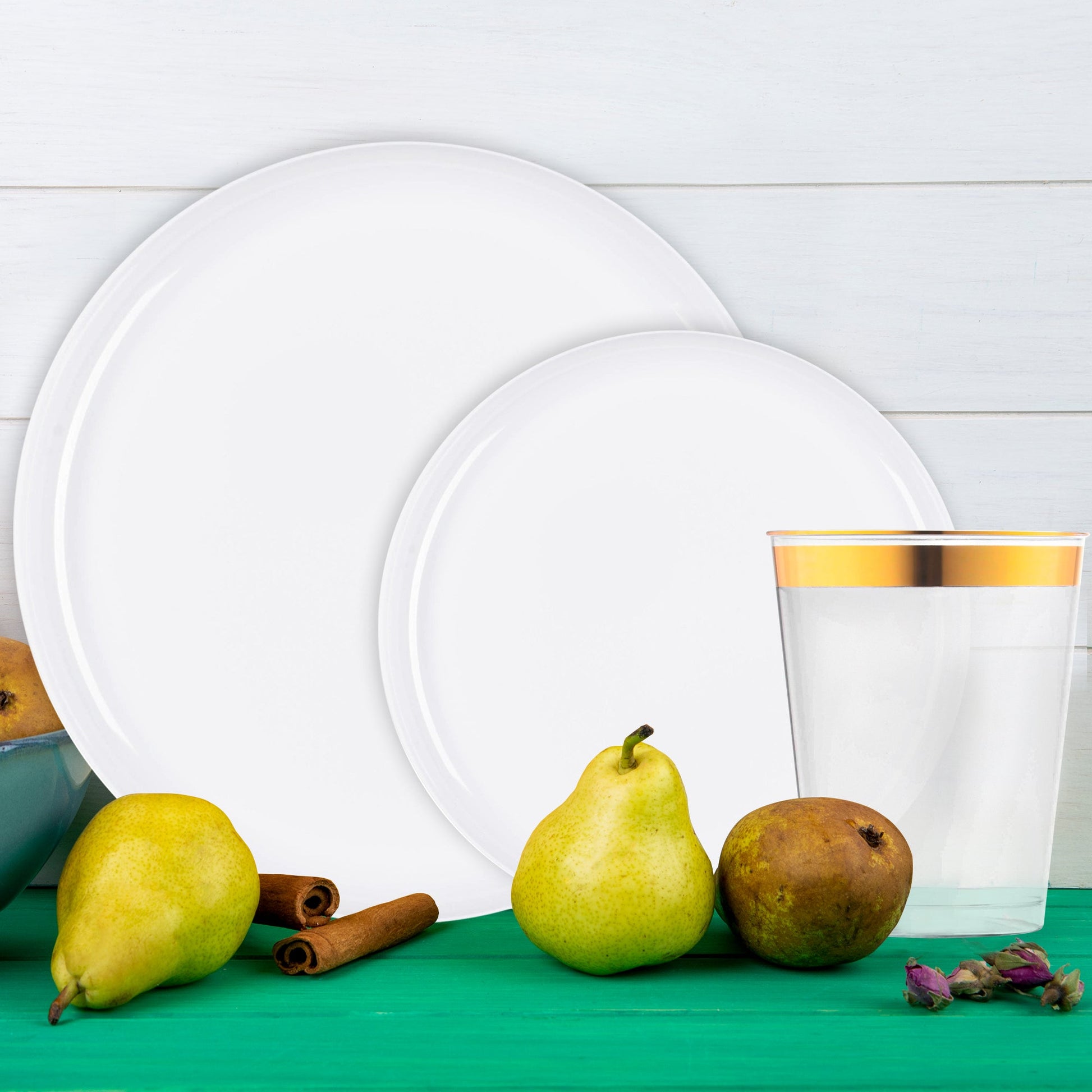 Elegant place settings featuring White Flat Round Plastic Tableware with gold utensils.