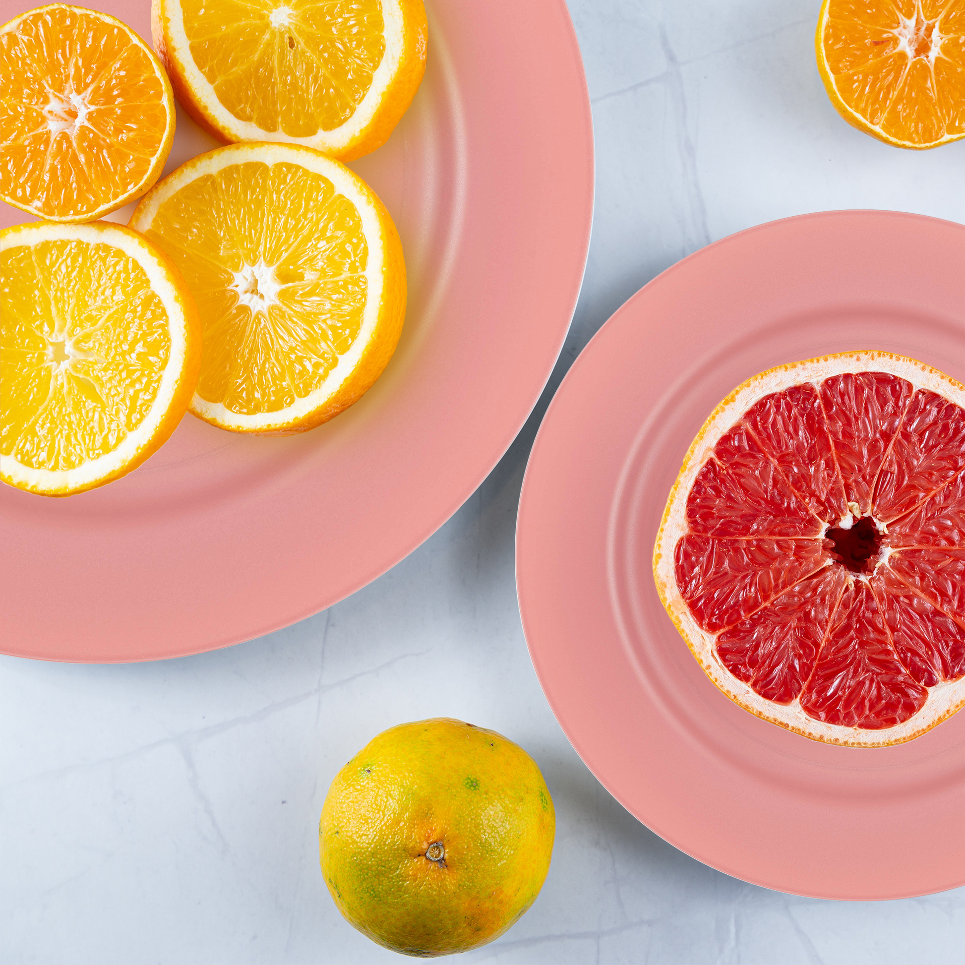 Fuchsia salad plates adding bold flair to a dessert table with colorful florals and vibrant linens