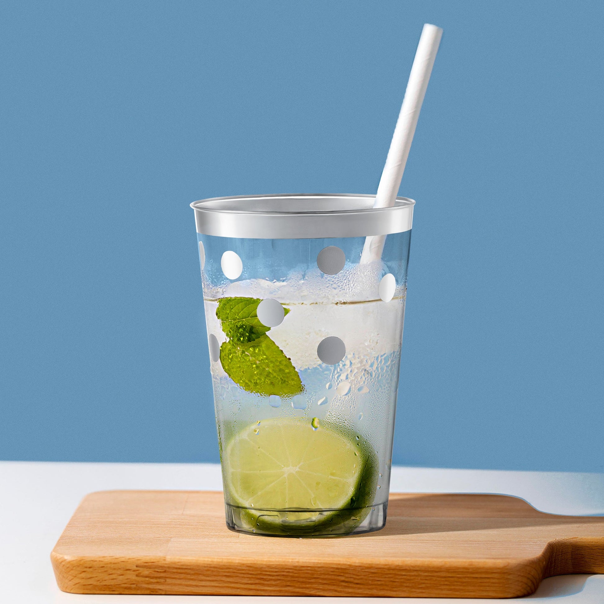 Sleek 12 oz. plastic tumblers with shimmering silver dots at a modern cocktail setup