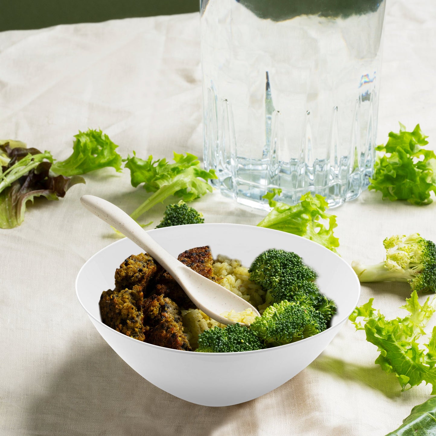 Solid White Organic Round Disposable Plastic Dessert Bowl containing a hearty serving of rice, tender meat, and steamed broccoli