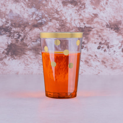 Stylish plastic tumblers with gold dots filled with drinks, enhancing a chic party scene