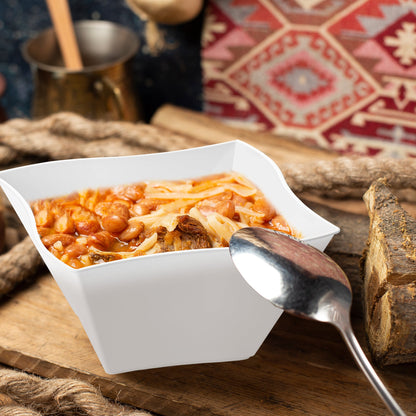 White Wave Plastic Soup Bowl (14 oz.) filled with hearty chili, topped with melted cheese and red beans