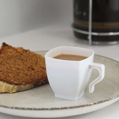 White disposable square mini tea cups, 2 oz., made of durable plastic for easy single-use convenience at parties and gatherings