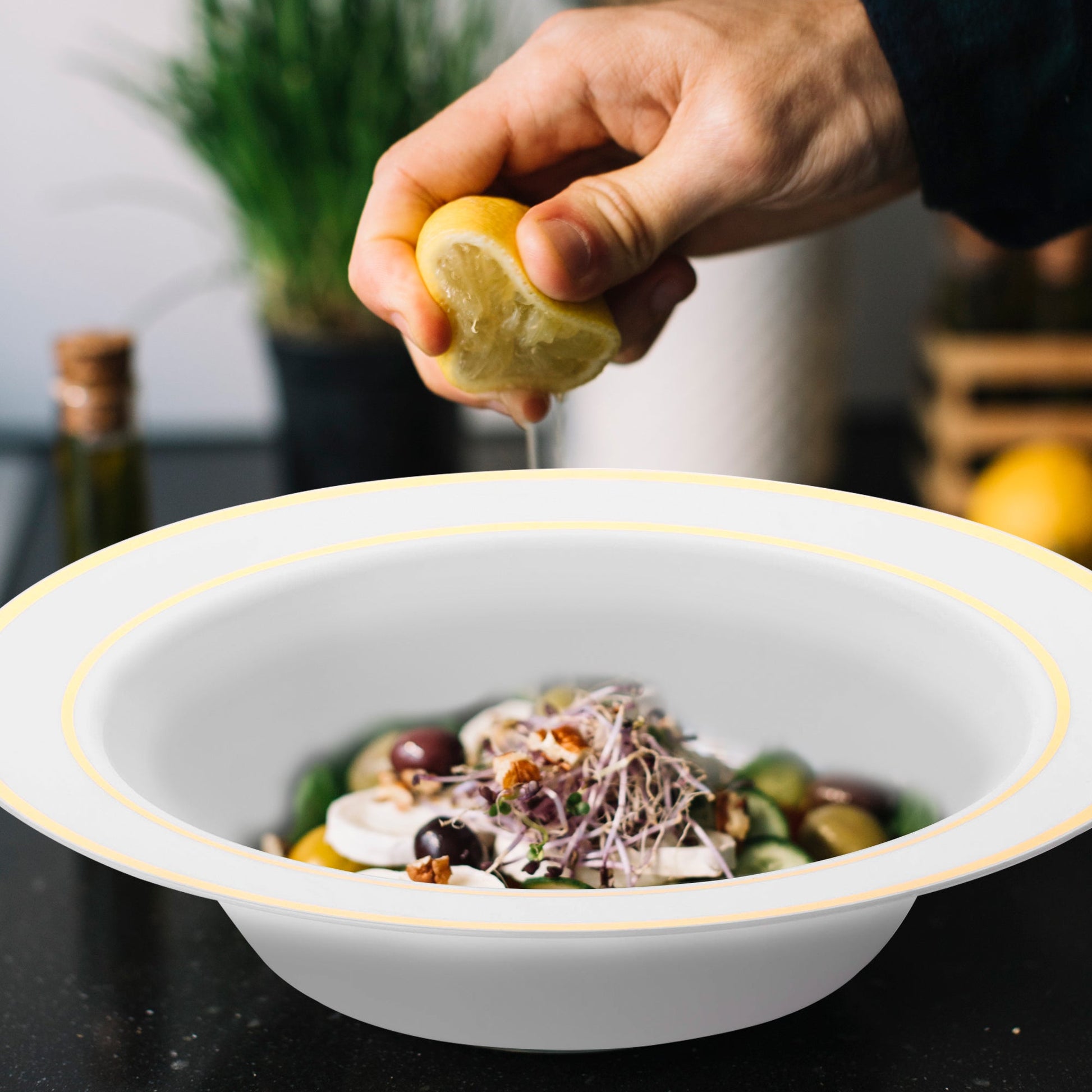 White with Gold Edge Rim Round Disposable Plastic Dessert Bowl filled with fresh salad, olives, and sliced onions